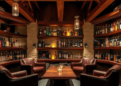 "Warm and inviting basement whiskey lounge with weathered wooden beams, flickering candlelight on aged stone walls, mahogany shelves displaying whiskey bottles and handcrafted glasses, plush leather armchairs around a reclaimed wood table, and soft jazz ambiance for intimate conversations."